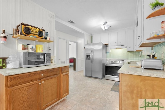 kitchen featuring stainless steel appliances, ornamental molding, white cabinets, and tasteful backsplash