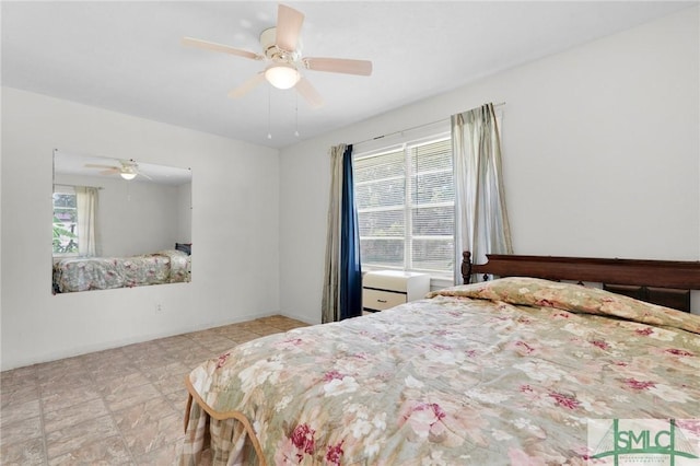 bedroom with ceiling fan and multiple windows