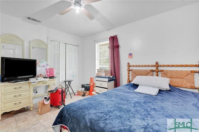 bedroom with ceiling fan and a closet