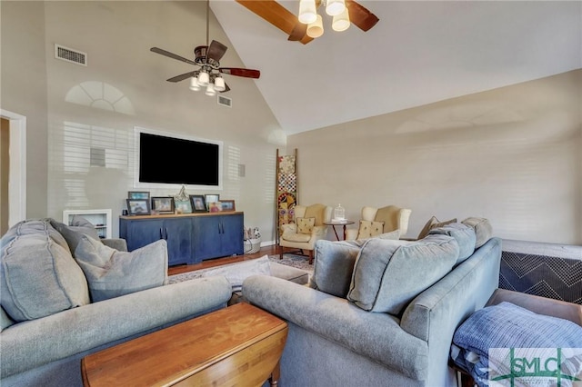 living room with ceiling fan, hardwood / wood-style floors, and high vaulted ceiling