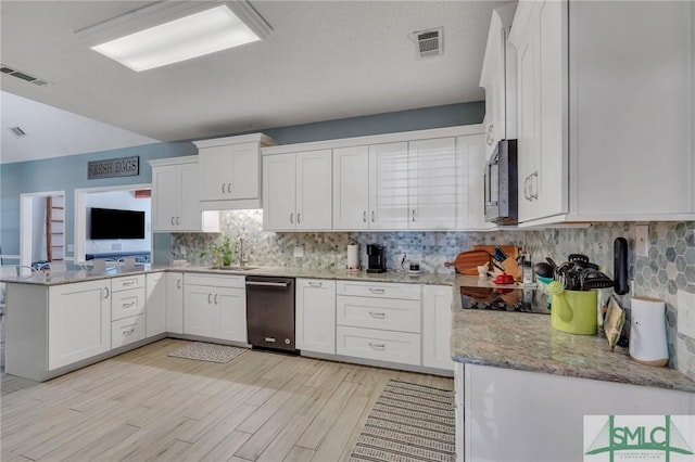 kitchen featuring kitchen peninsula, appliances with stainless steel finishes, sink, and white cabinetry