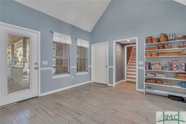 interior space featuring high vaulted ceiling and light wood-type flooring