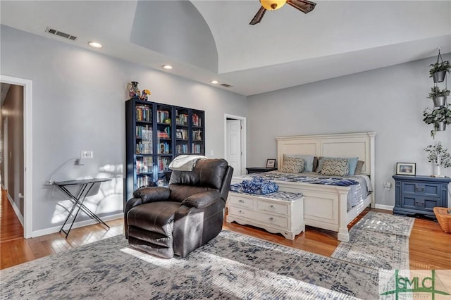 bedroom with vaulted ceiling, ceiling fan, and light wood-type flooring