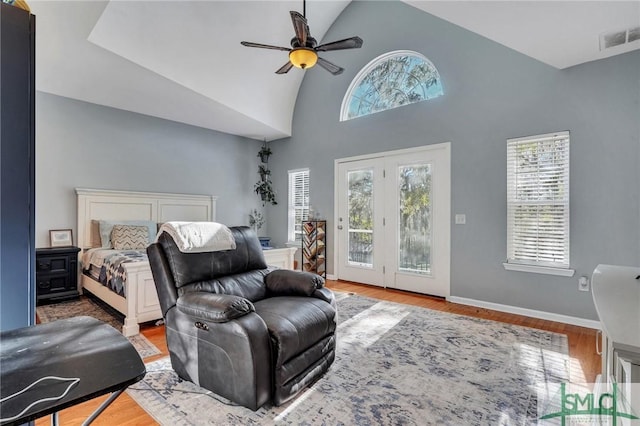 bedroom featuring ceiling fan, access to exterior, lofted ceiling, and wood-type flooring