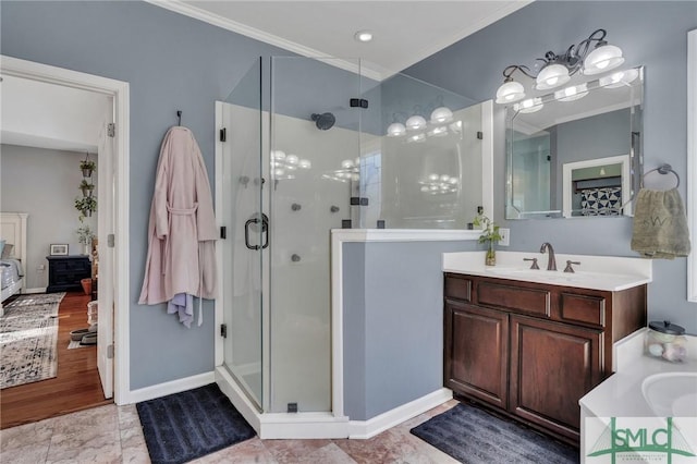 bathroom featuring an enclosed shower, vanity, and ornamental molding