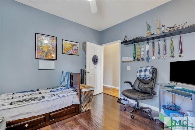 bedroom with ceiling fan and dark hardwood / wood-style flooring