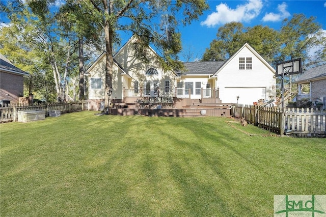 rear view of house with a deck and a lawn