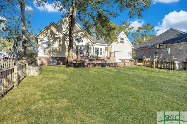 rear view of house featuring a wooden deck and a lawn