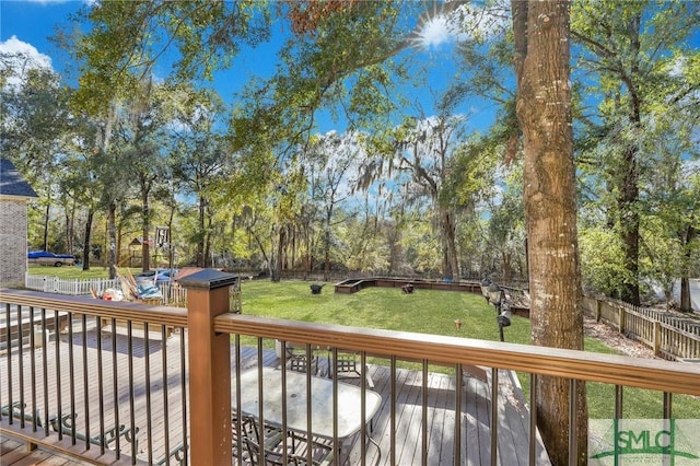 deck featuring a patio area and a lawn