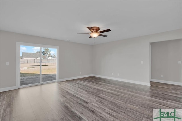 empty room featuring hardwood / wood-style flooring and ceiling fan