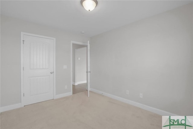 unfurnished bedroom featuring a closet and light carpet