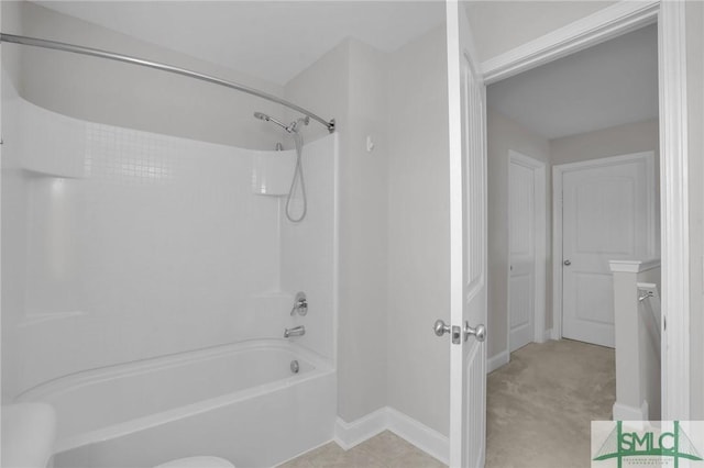 bathroom featuring shower / washtub combination and toilet