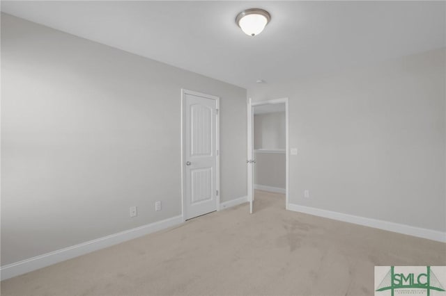 unfurnished bedroom featuring light carpet