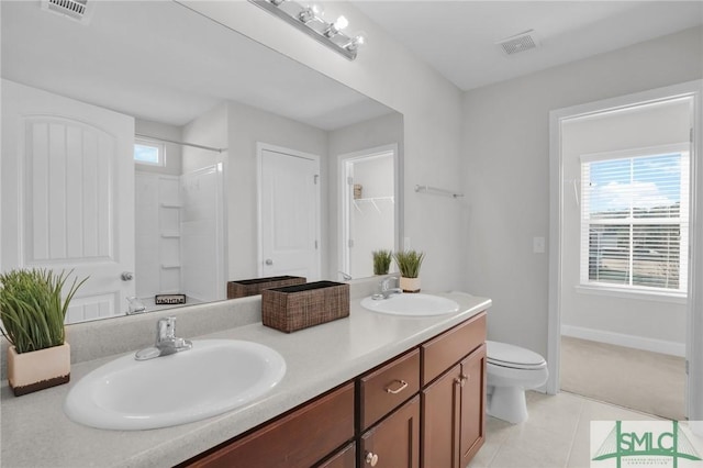 bathroom with toilet, tile patterned flooring, a shower, and vanity