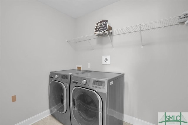 clothes washing area with separate washer and dryer