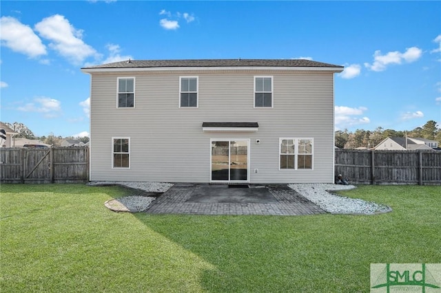 back of property with a lawn and a patio