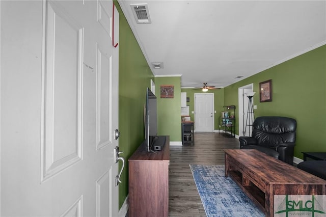 living room with ceiling fan, dark wood-type flooring, and crown molding