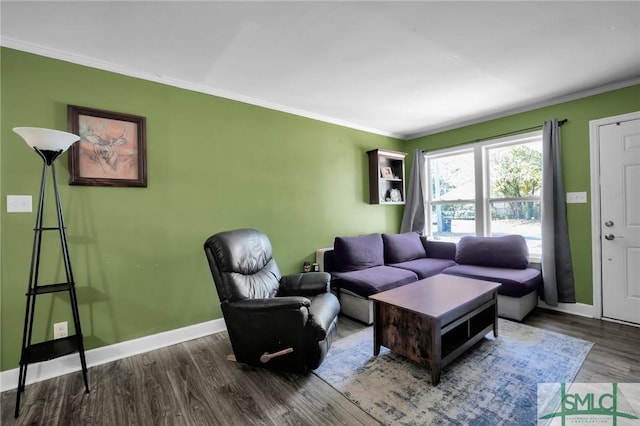 living room with dark hardwood / wood-style floors and crown molding