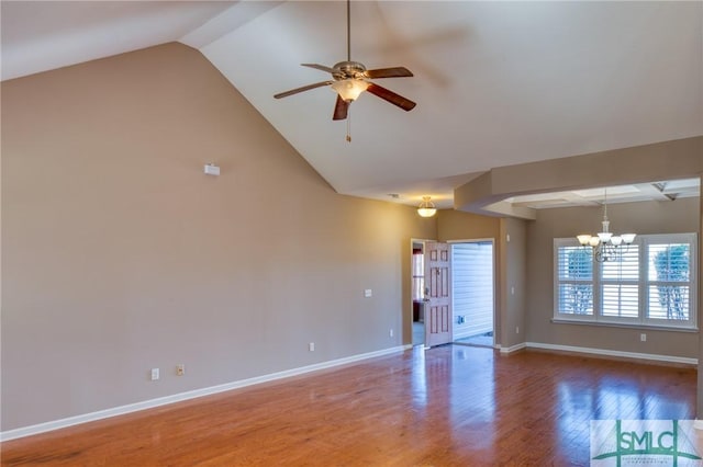 unfurnished living room with ceiling fan with notable chandelier and wood-type flooring