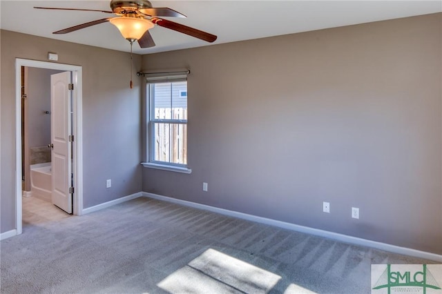 unfurnished bedroom featuring light carpet, ensuite bath, and ceiling fan