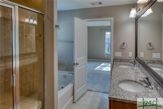 bathroom with vanity and separate shower and tub