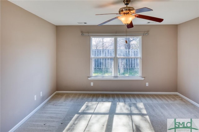 empty room featuring light colored carpet and ceiling fan