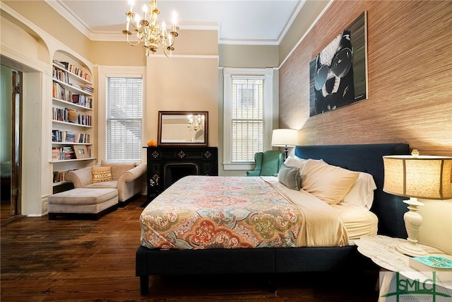 bedroom with hardwood / wood-style floors, crown molding, and a chandelier