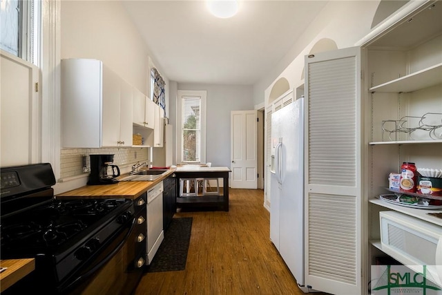 kitchen with butcher block countertops, backsplash, white appliances, dark wood-type flooring, and white cabinets