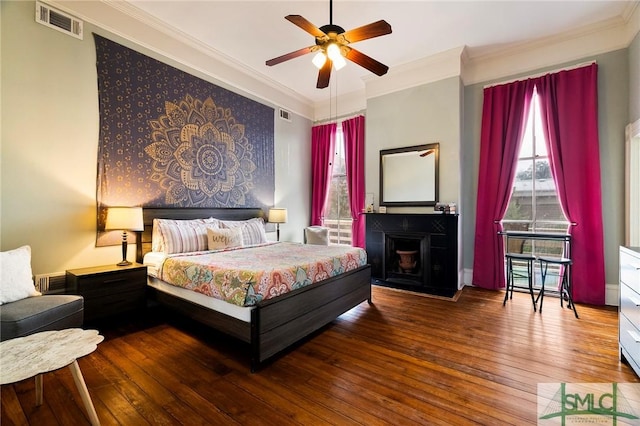 bedroom featuring ceiling fan, ornamental molding, and hardwood / wood-style floors