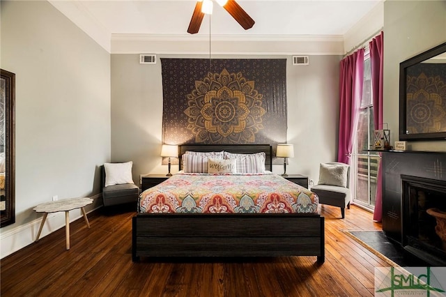 bedroom featuring ceiling fan, hardwood / wood-style flooring, and crown molding