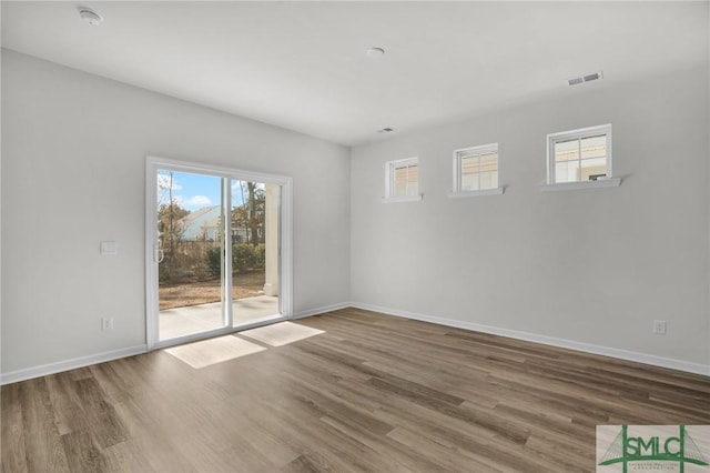 spare room featuring hardwood / wood-style floors