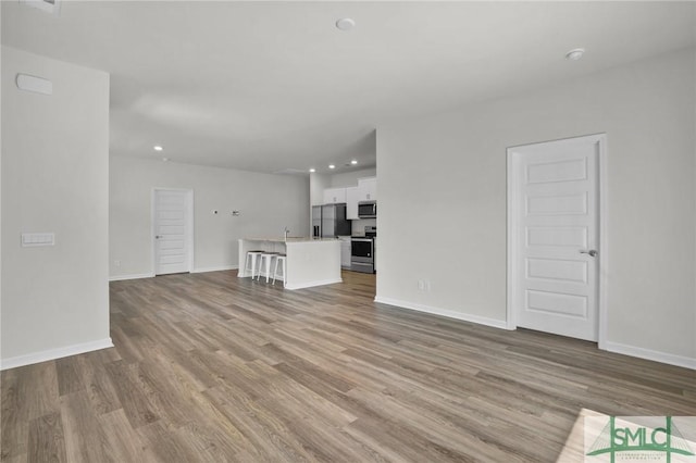 unfurnished living room featuring light hardwood / wood-style flooring