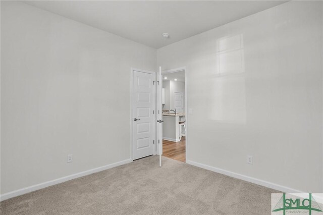 carpeted empty room with sink