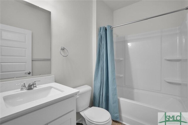 full bathroom with shower / bath combo with shower curtain, toilet, and vanity