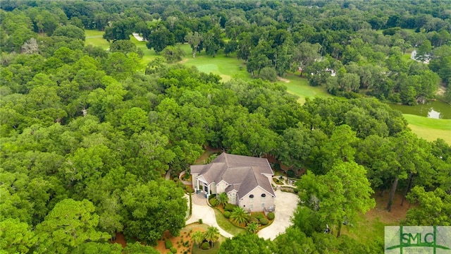 birds eye view of property with a water view and a wooded view