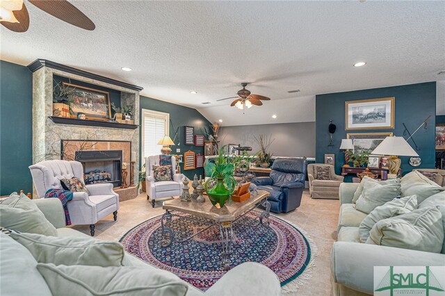 living area with recessed lighting, a ceiling fan, light tile patterned flooring, a stone fireplace, and a textured ceiling