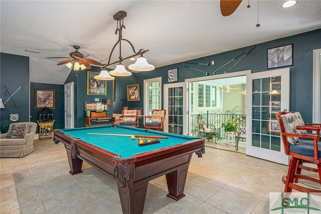 recreation room with french doors, light tile patterned floors, pool table, a ceiling fan, and a textured ceiling