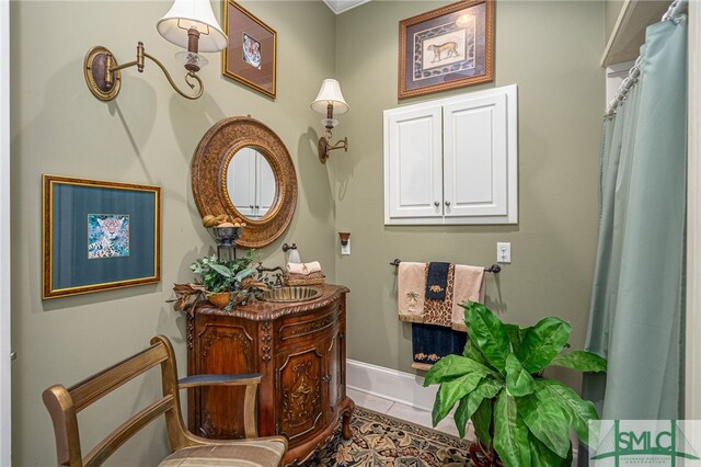 full bathroom featuring vanity, baseboards, and tile patterned floors