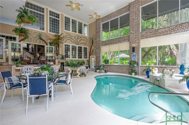 pool featuring outdoor dining space, a patio area, and ceiling fan