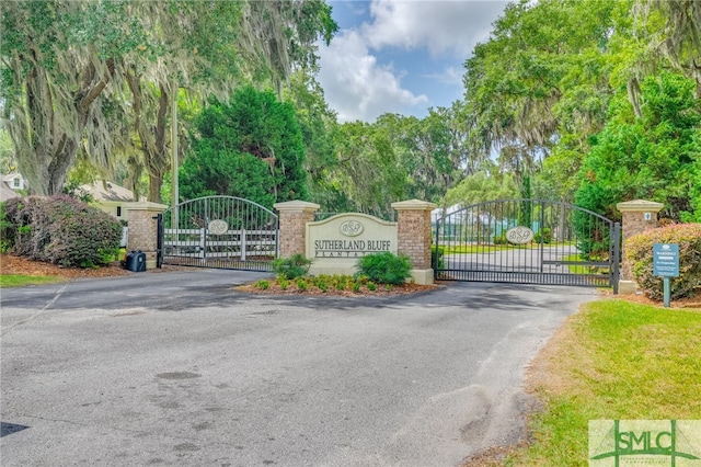 exterior space featuring a gate and aphalt driveway