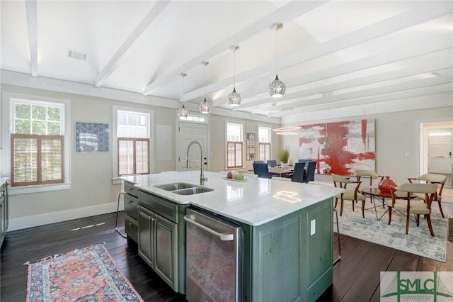 kitchen with sink, a kitchen island with sink, dark hardwood / wood-style floors, and hanging light fixtures