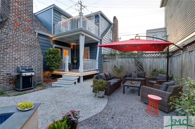 view of patio / terrace featuring an outdoor living space, a balcony, and a grill