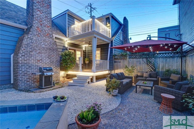 view of patio featuring a balcony, outdoor lounge area, a swimming pool, and area for grilling