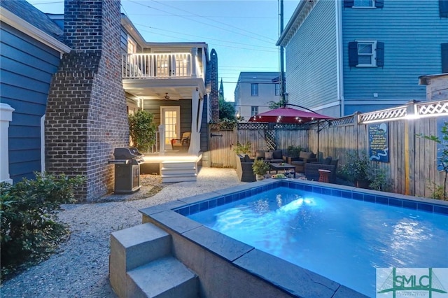 view of pool featuring a grill, an outdoor living space, and a patio