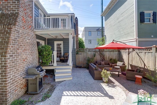 view of patio / terrace with a balcony, an outdoor hangout area, and grilling area