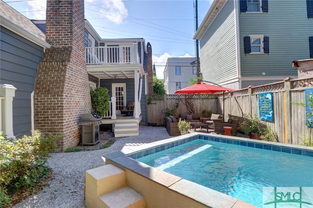 view of swimming pool featuring an outdoor hangout area and area for grilling