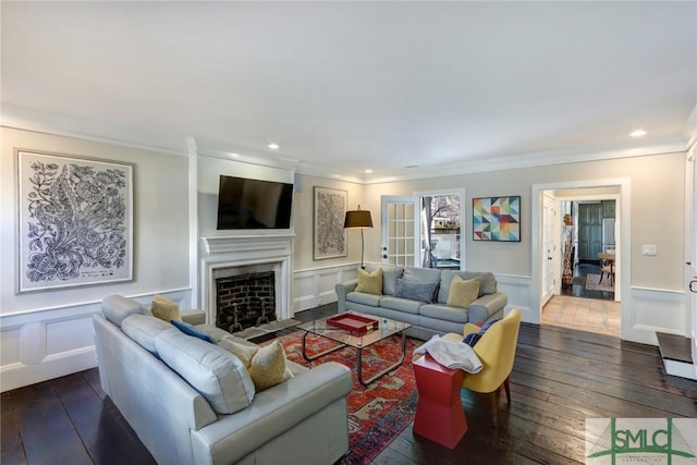 living room with ornamental molding and dark hardwood / wood-style flooring