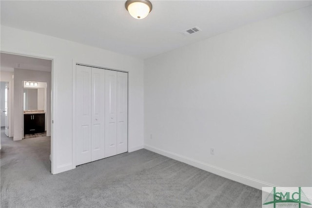 unfurnished bedroom with carpet and a closet