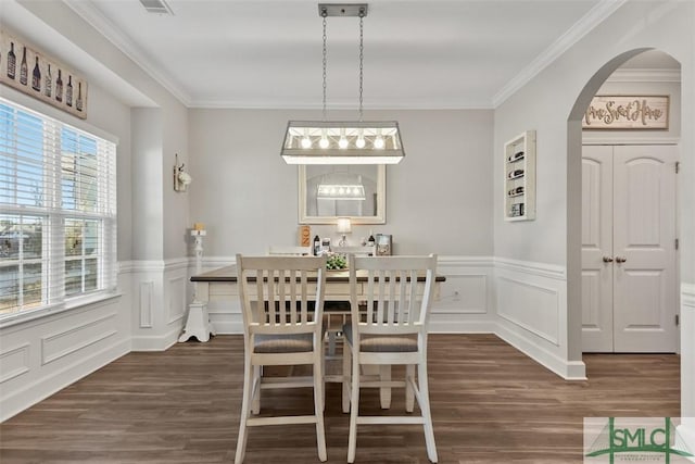 dining area with crown molding and dark hardwood / wood-style flooring