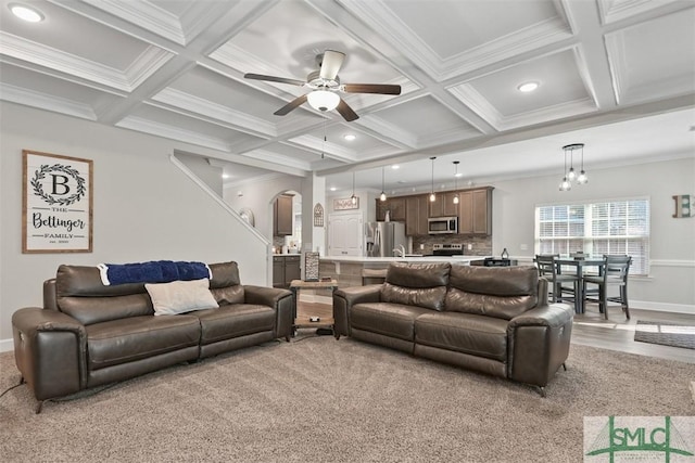 living room with light carpet, beam ceiling, ceiling fan, and ornamental molding